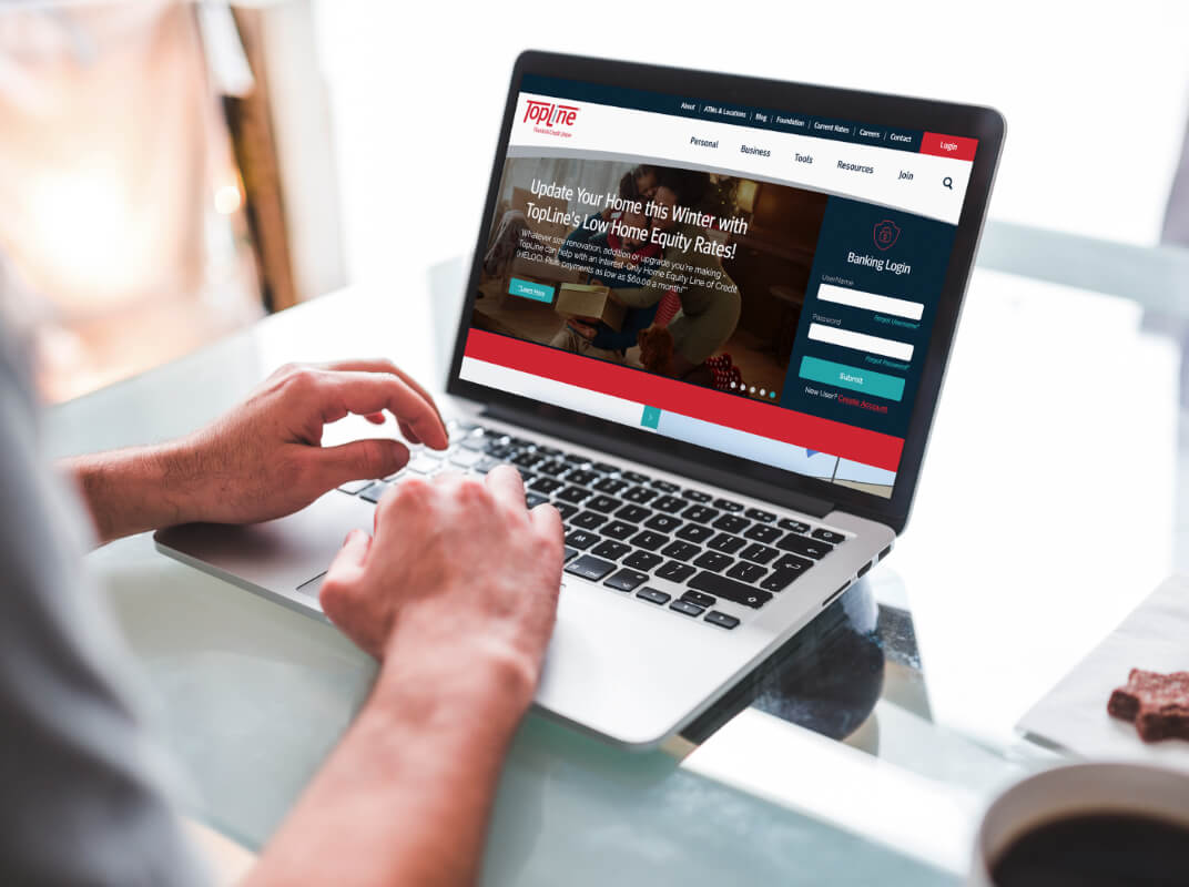 topline financial credit union website on a laptop