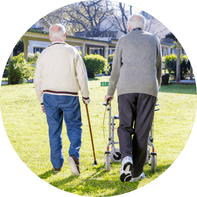 two elderly people walking on the lawn