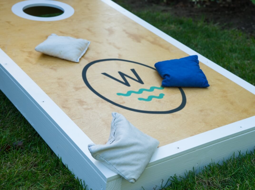 a wakpada branded cornhole board